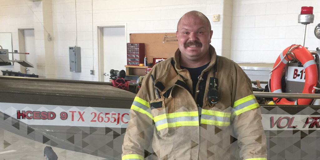 Marcus Capozzelli Smiles at the Local Firehouse in his firefighting gear.