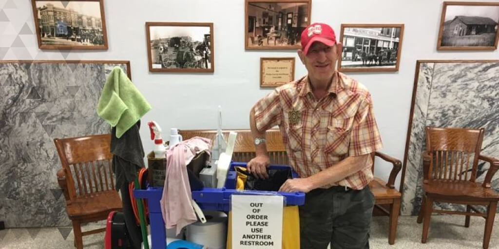 Nick smiles with his cleaning supplies at the courthouse.