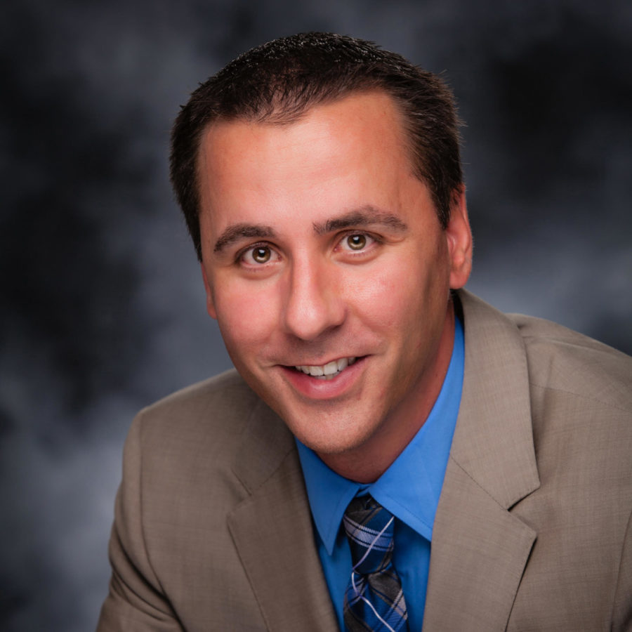 Scott Hoffman, a man with light skin and brown hair, smiles at the camera.